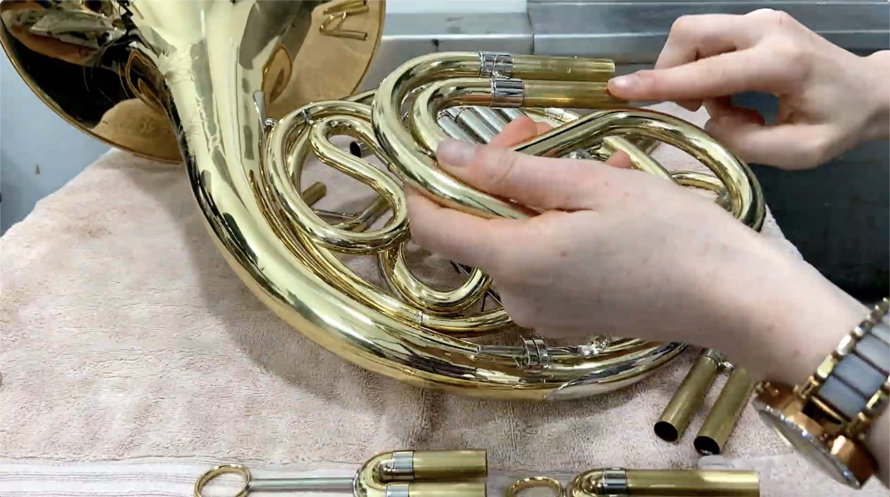 Greece is being applied to one of the French horn slides.