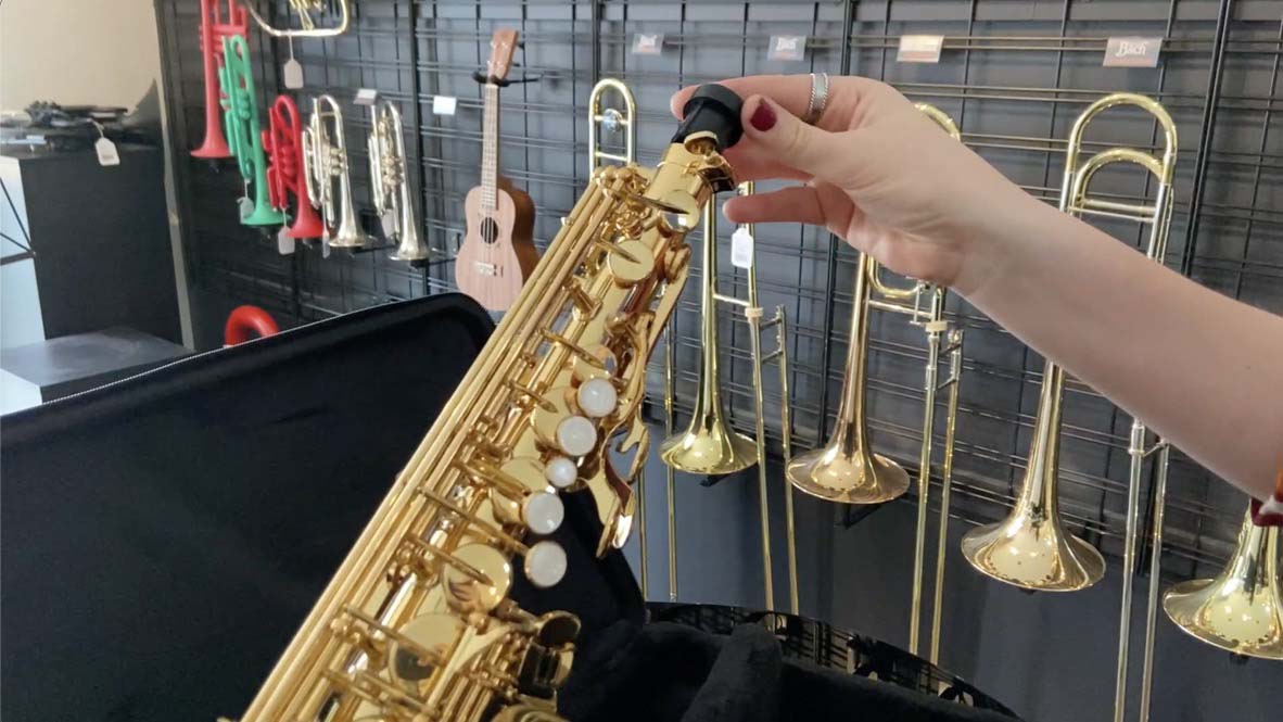 End cap being inserted into end of saxophone body.