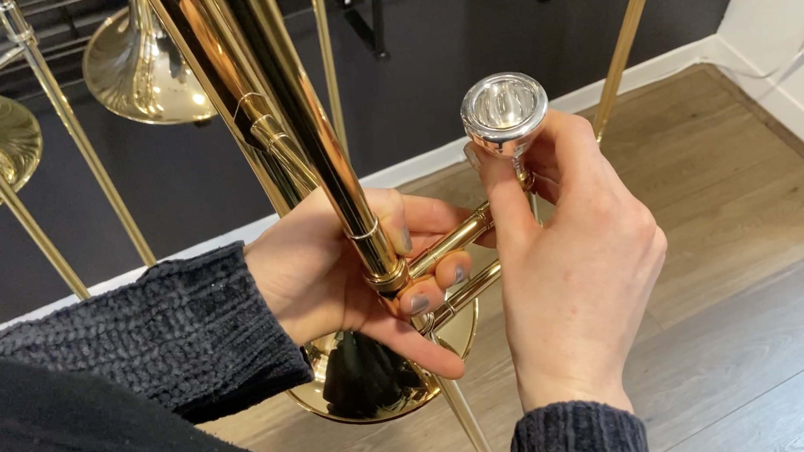 Trombone mouthpiece being inserted into the mouthpiece receiver.